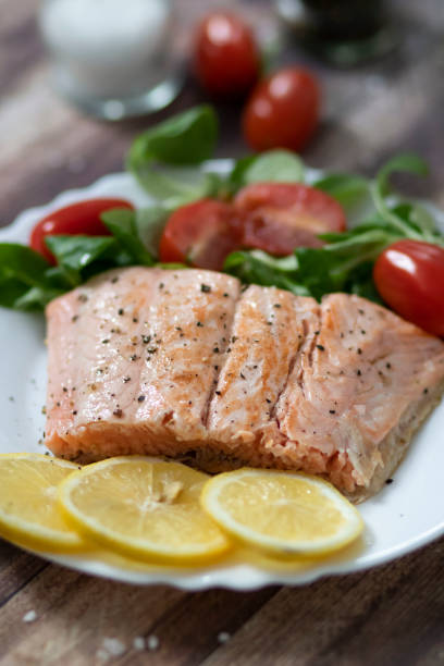 istock Salmon in a pan with lemon and other vegetables. 1289182274