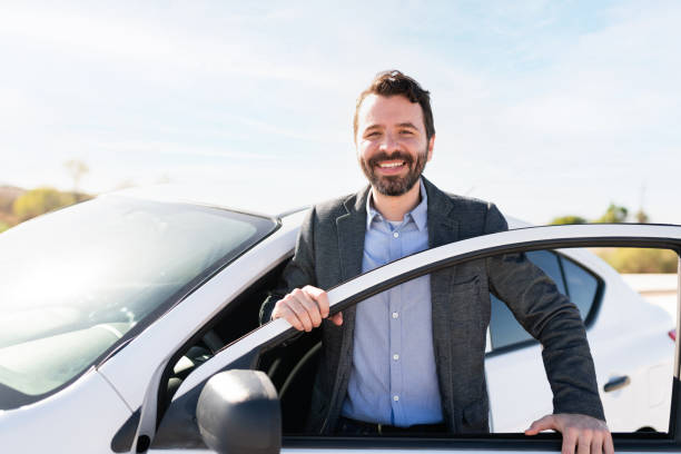 istock Latin man making eye contact while smiling and getting off a vehicle 1289183809