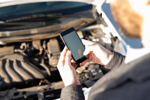 istock Latin man texting a mechanic on the roadside 1289186460