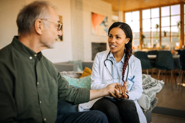 istock Doctor comforting patient at patient's home 1289186582