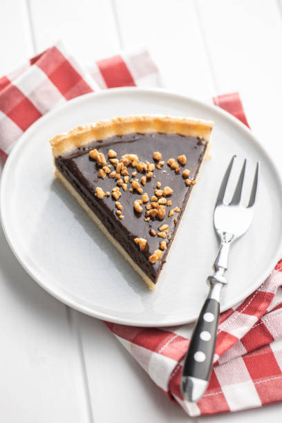 istock Sweet chocolate pie with crushed nuts. 1289188983