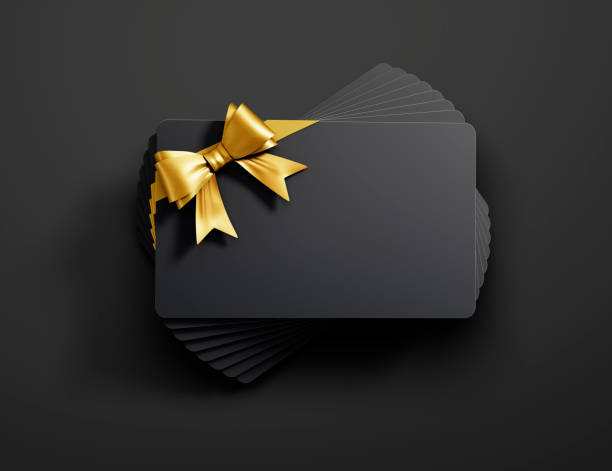tarjetas de regalo apiladas con arco empatado - gift card gift certificate gift gold fotografías e imágenes de stock