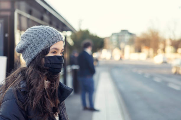 istock Girl wearing protective face mask at a bus stop 1289191718