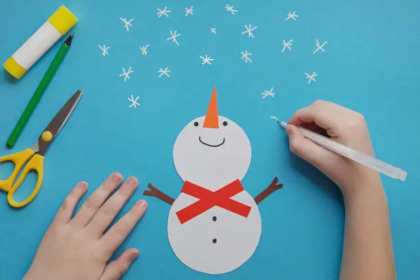 Photo of Crafts for children. Easy Winter Crafts for kids. little child creative card Snowman from paper. DIY concept. Handmade Easy Paper Crafts For Kids