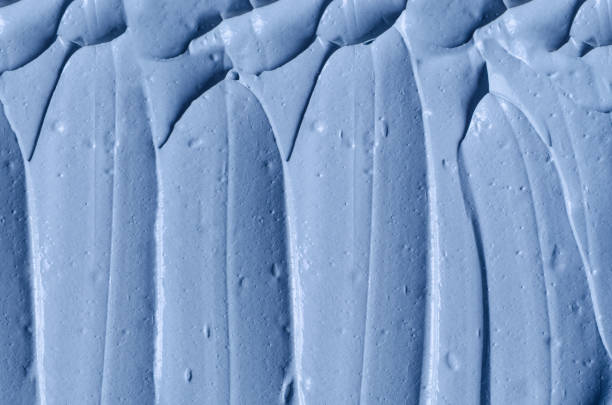 istock Light blue facial clay (mask, face cream, body wrap) texture close up, selective focus. Abstract background with brush strokes. 1289192903