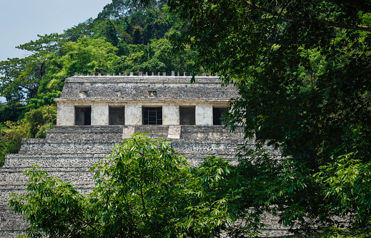 Temple of the inscriptions at the archaeological Mayan site surrounded by tropical forest in Palenque, Chiapas, Mexico