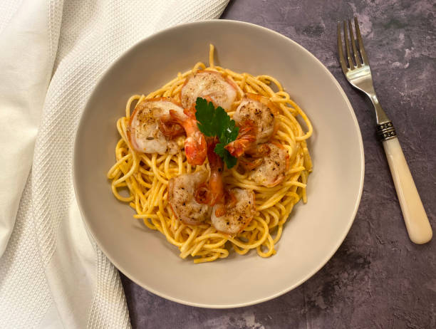 istock Classic pasta dish, creamy, prawn king prawn linguine, also known as linguini gamberetti. 1289197314