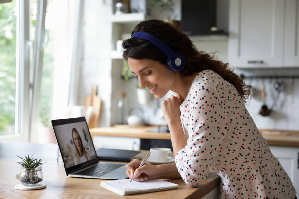 Smiling woman talk on video call studying