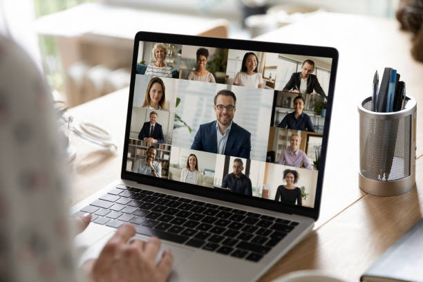 istock Back view of employee talk on video call with colleagues 1289197482