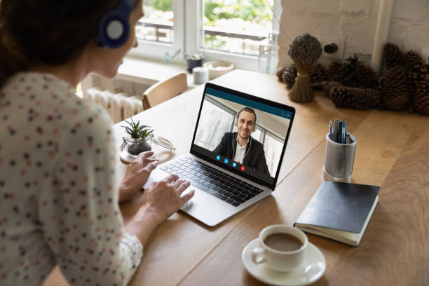 istock Female employee talk on video call with male client 1289197497