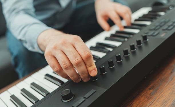 istock Man playing the piano in studio, recording new song. 1289199947