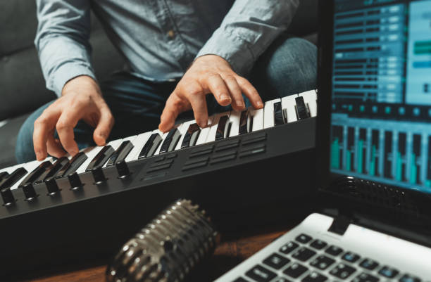 istock Man playing the piano in studio, recording new song. 1289199998