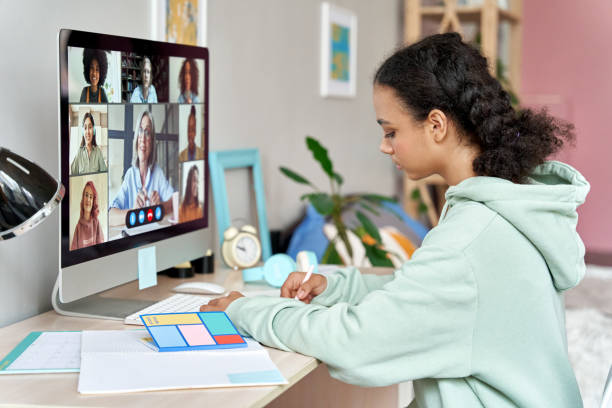 istock African teenager high school student remote learning online group class at home. Mixed race teen girl distance studying during virtual class, group online lesson on video conference call with teacher. 1289202048