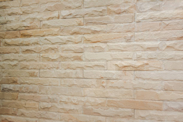 istock Wall lined with limestone slabs beige. Concept natural mineral background for the design. 1289202287