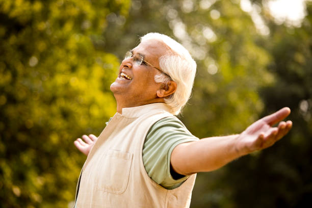 istock Carefree elderly men with arms outstretched at park 1289202618