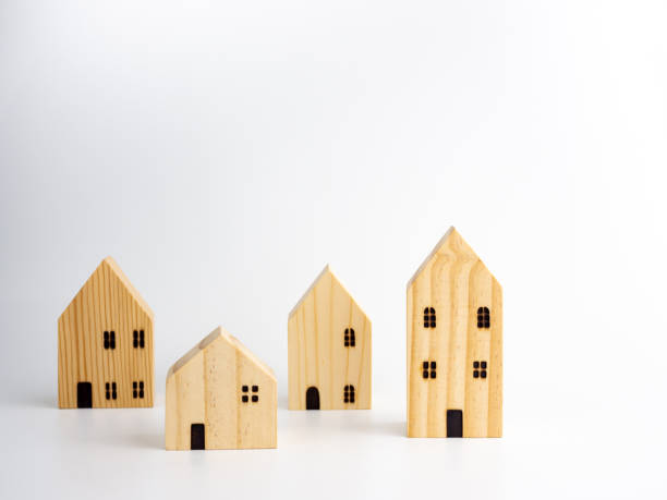 istock Wooden Miniature houses on white background. 1289203308