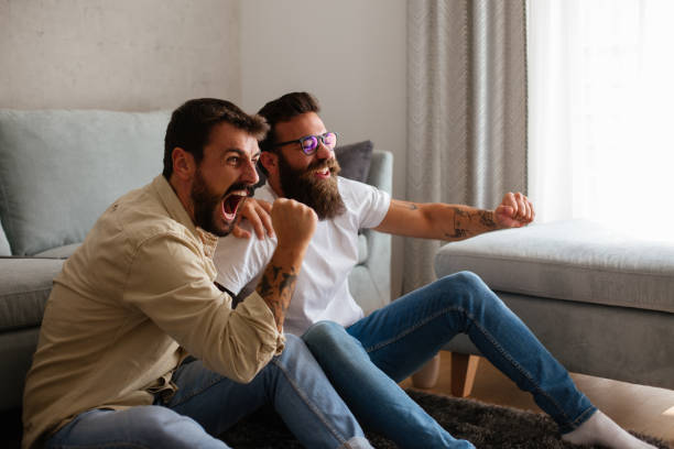 istock Two friends are watching exciting sport event on TV. 1289203363