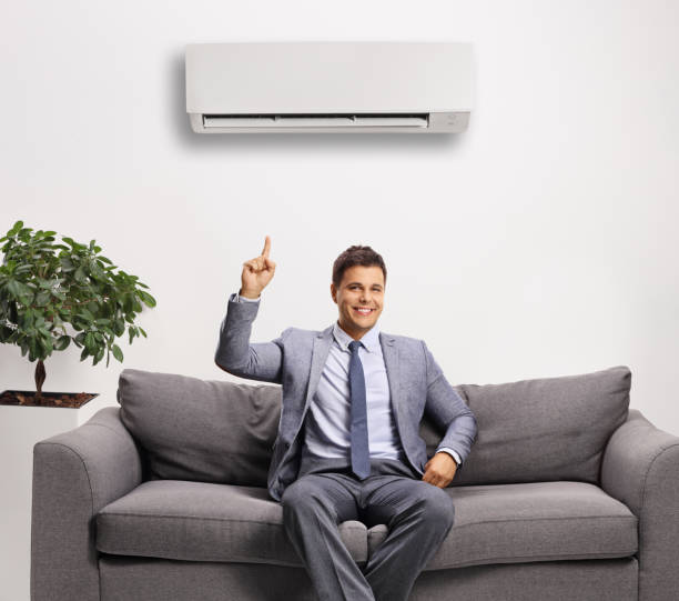 istock Professional man in a suit sitting under an air-contirioner 1289203435
