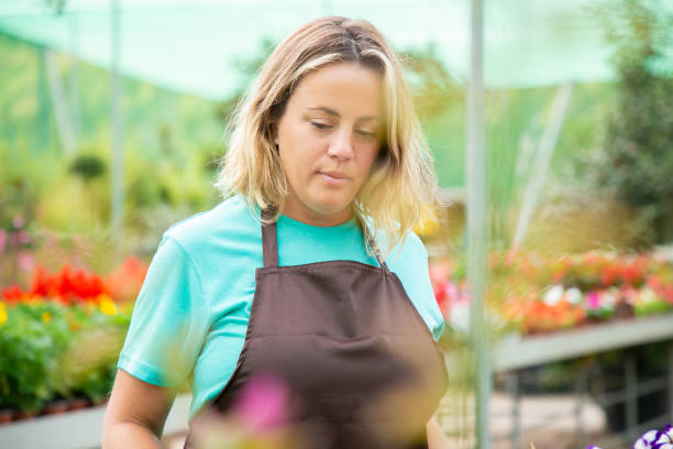 istock Thoughtful female gardener looking down at something 1289203532