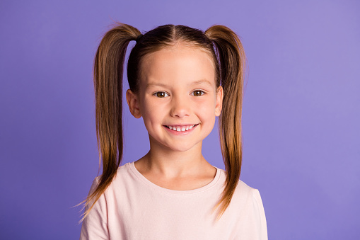 Photo of cute pretty small little girl beaming nice smile good mood isolated on violet color background.