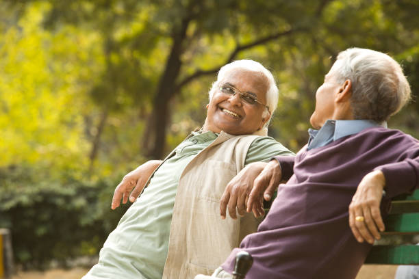 istock Two pleased elderly men discussion at park 1289205296