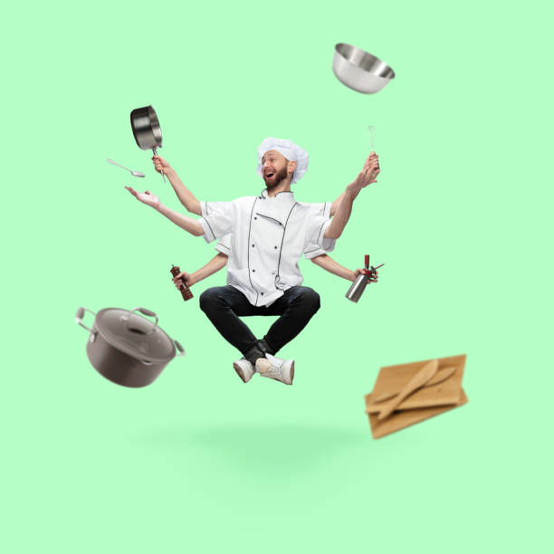 istock Happy handsome multi-armed chief-cooker levitating isolated on green studio background with equipment 1289205335