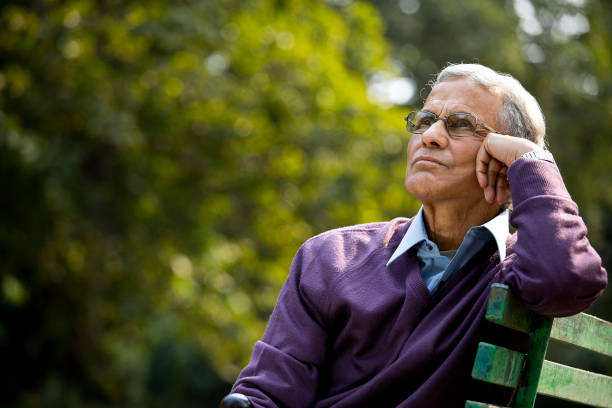 Thoughtful senior man sitting at park