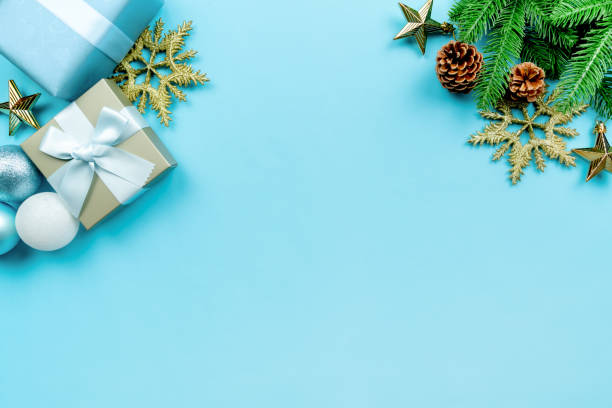 istock Christmas present and pine tree with xmas decoration on blue background 1289207930