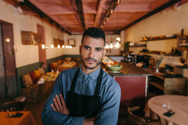 istock Handsome african american waiter looking at camera. 1289208893