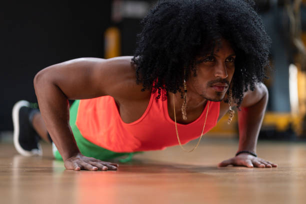istock Portrait of a black man with afro doing a push-up 1289210795