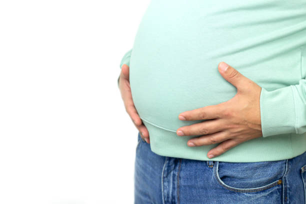 istock Fat man with big beer belly isolated on white background 1289211273