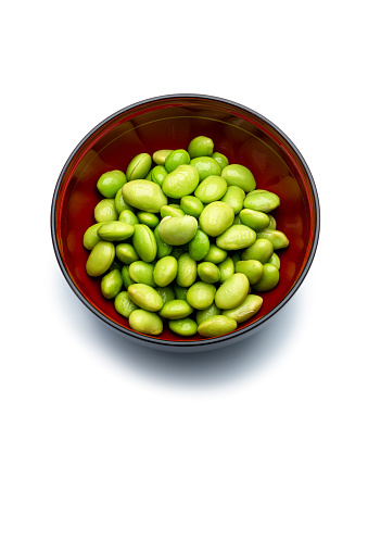 Edamame or soybeans in a wooden bowl on white background, , isolated on a white background, high angle view