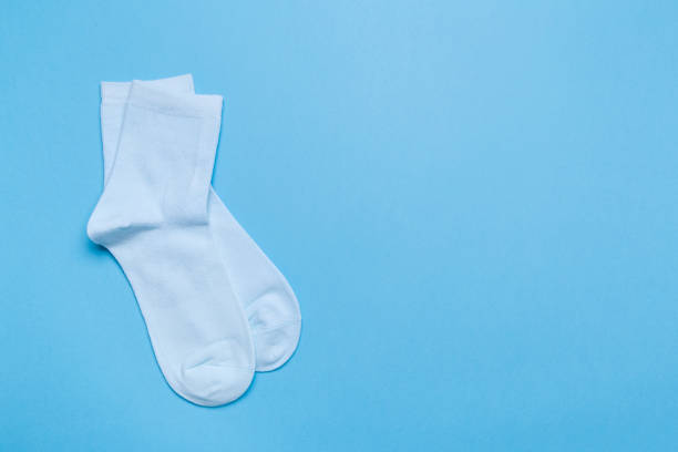 istock blue new socks stacked on a blue background. top view. place for text. 1289212837