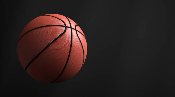 istock Basketball ball in flight. Dark background. Copy space. 1289212892