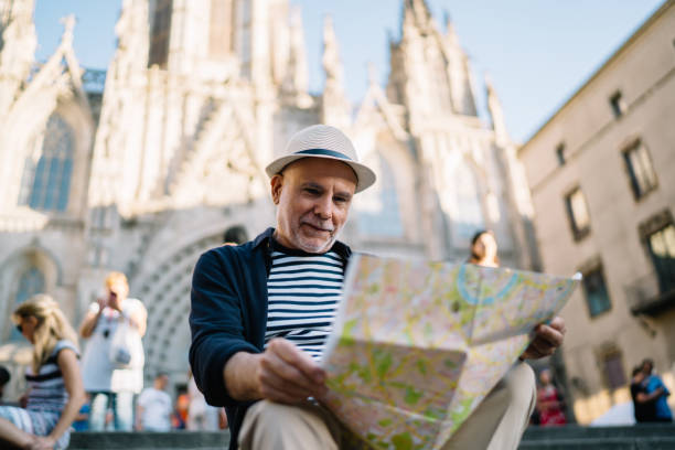 istock Cheerful senior man with map on street 1289213606