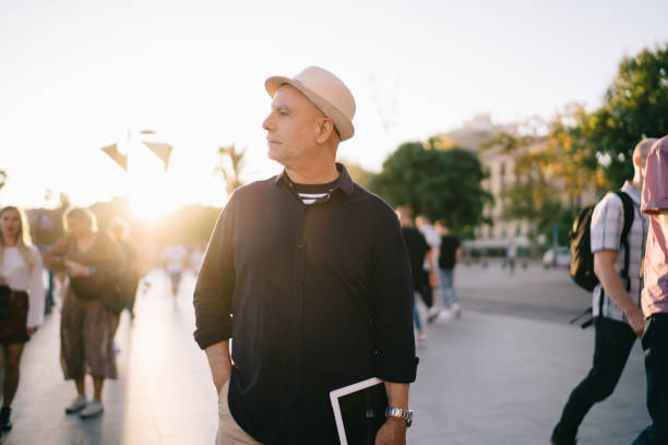 istock Thoughtful 50 years old man with tablet in public place 1289213621