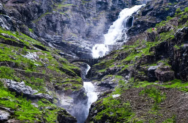 Photo of Stigfossen waterfall near Trollstigen or Troll Stairs, a serpentine mountain road that is popular tourist attraction. Notway.