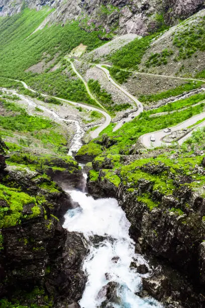 Photo of Stigfossen waterfall near Trollstigen or Troll Stairs, a serpentine mountain road that is popular tourist attraction. Notway.