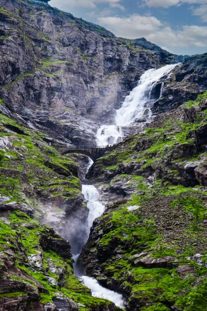 Photo of Stigfossen waterfall near Trollstigen or Troll Stairs, a serpentine mountain road that is popular tourist attraction. Notway.