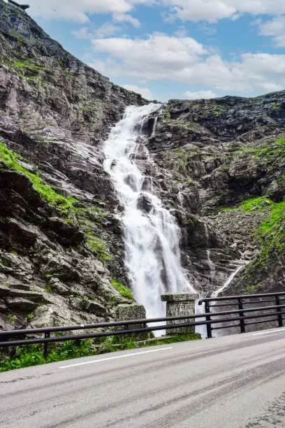 Photo of Stigfossen waterfall near Trollstigen or Troll Stairs, a serpentine mountain road that is popular tourist attraction in Norway.