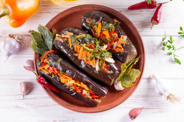 istock Eggplant slices stuffed vegetables in a plate on a table. Top view 1289213788