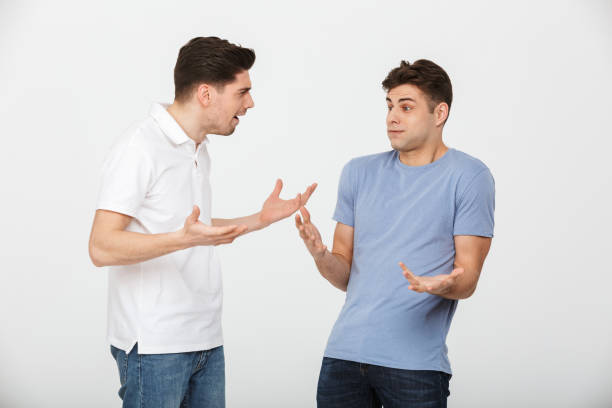 istock Portrait of two confused young men talking 1289214987