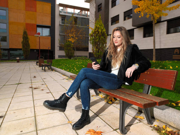 istock Young woman checking messages on her mobile phone 1289215305