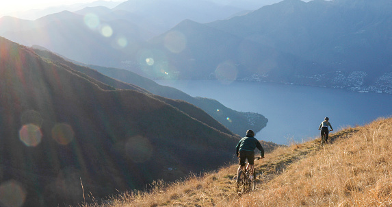 Sun shines over distant Swiss Alps, Lake Maggiore visible below