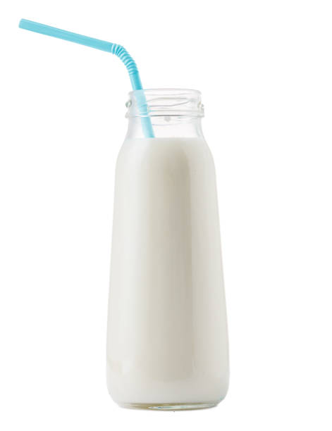 istock Glass cup of milk with a straw isolated on white 1289215752