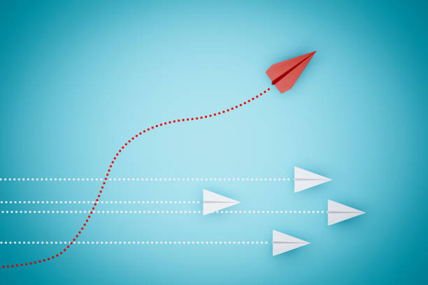 istock one red paper plane pointing in different way on blue background. Business for new ideas creativity and innovative solution concepts. 3D rendering 1289217092