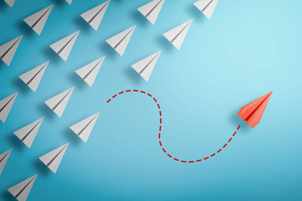 istock one red paper plane pointing in different way on blue background. Business for new ideas creativity and innovative solution concepts. 3D rendering 1289217104