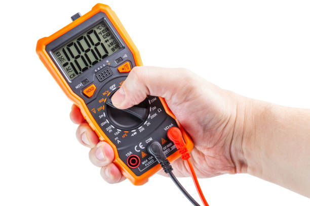 istock lcd screen digital electrical multimeter in right hand, isolated on white background, mockup with all on 1289219421
