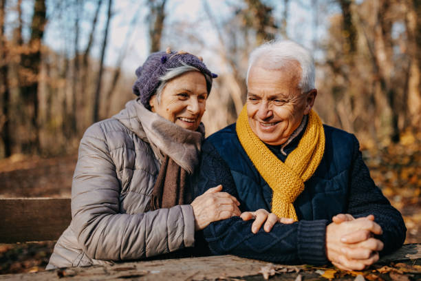 istock Senior couple sitting in the bench park 1289219492