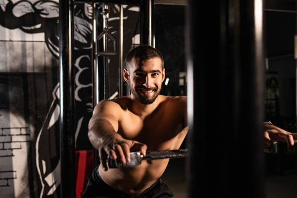 istock Muscular young man with smile on his face doing chest work out 1289220638